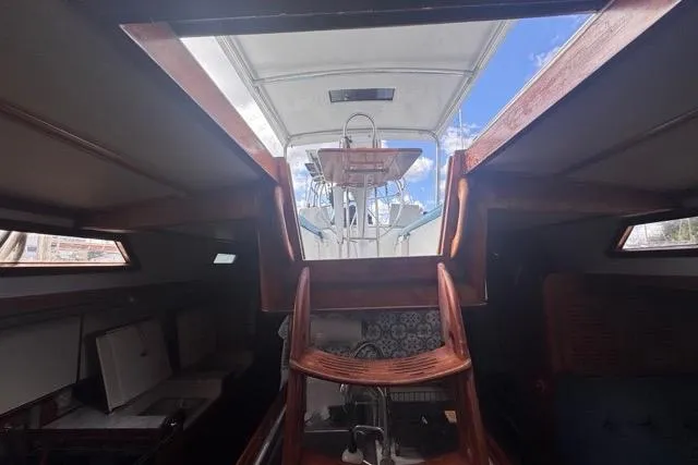 Pickle Yacht Photos Pics Interior view of a 1989 Hylas 44 sailboat, showcasing wooden stairs and cockpit.