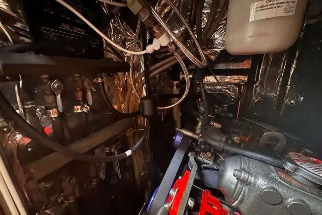 Pickle Yacht Photos Pics Engine room of a 1989 Hylas 44 yacht, showcasing mechanical components and wiring.