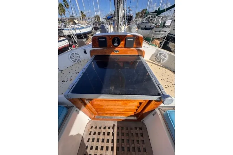 Pickle Yacht Photos Pics Cockpit of 1989 Hylas 44 sailboat with wooden details and navigation instruments.