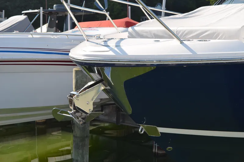  Yacht Photos Pics 2023 Regal 36 Grande Coupe yacht docked, showcasing sleek bow design and anchor.