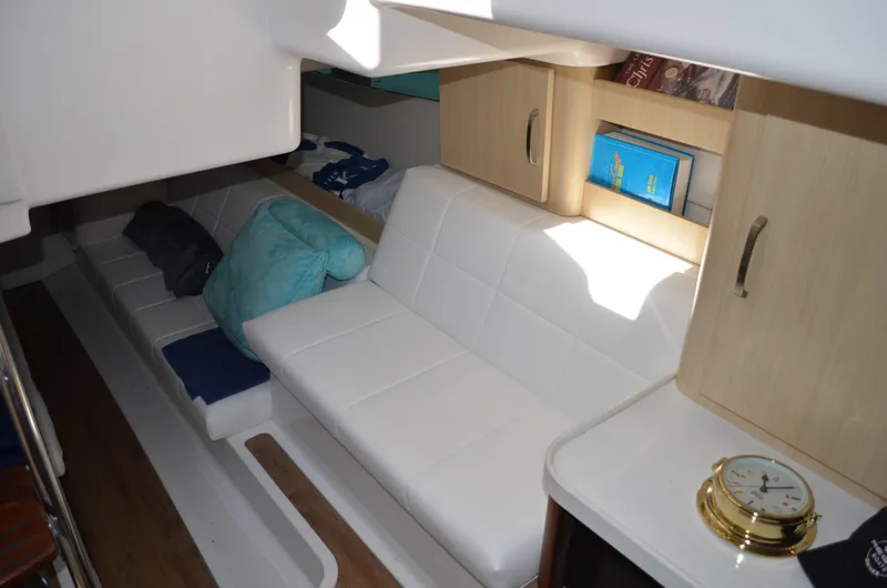  Yacht Photos Pics Interior of 2023 Regal 36 Grande Coupe with white seating and wooden cabinetry.