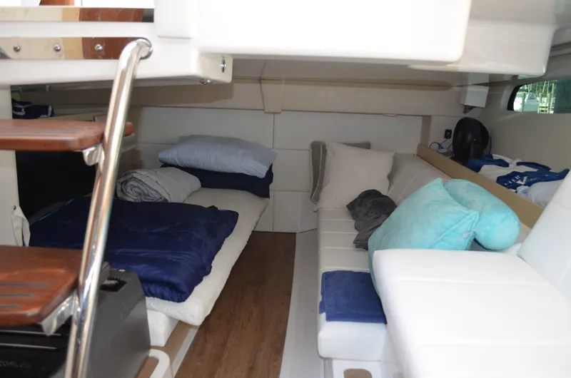  Yacht Photos Pics 2023 Regal 36 Grande Coupe interior with cozy seating and bedding.