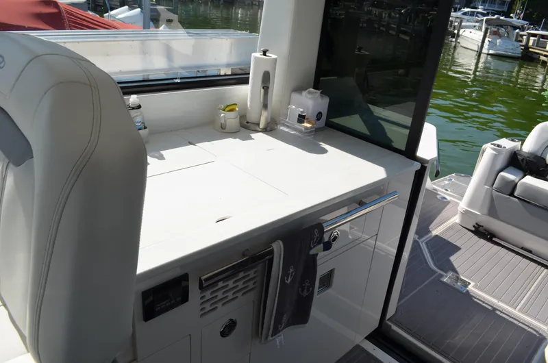  Yacht Photos Pics 2023 Regal 36 Grande Coupe yacht interior with sleek kitchenette and modern amenities.