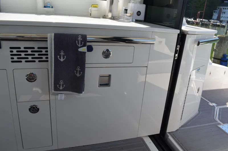  Yacht Photos Pics 2023 Regal 36 Grande Coupe yacht interior with sleek cabinetry and nautical-themed towel.