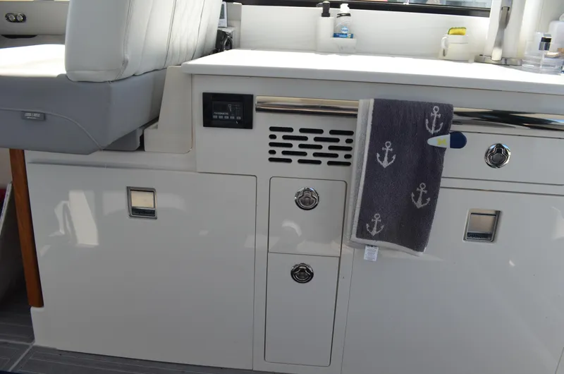  Yacht Photos Pics 2023 Regal 36 Grande Coupe interior with anchor-themed towel and modern cabinetry.