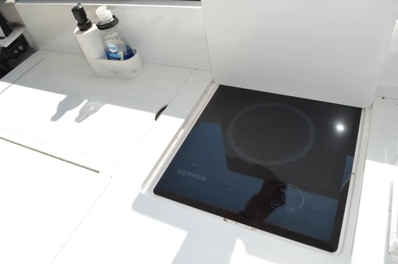  Yacht Photos Pics 2023 Regal 36 Grande Coupe yacht kitchen with Kenyon induction cooktop and soap dispensers.