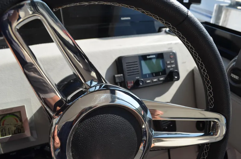  Yacht Photos Pics Steering wheel of 2023 Regal 36 Grande Coupe with navigation display.