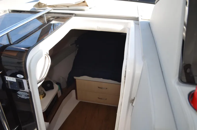  Yacht Photos Pics 2023 Regal 36 Grande Coupe cabin interior with bed and storage drawers.