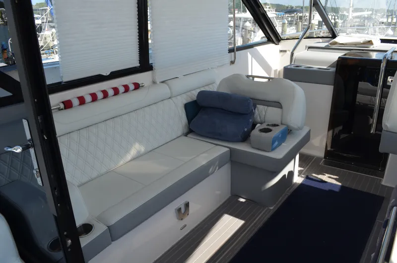  Yacht Photos Pics Interior of 2023 Regal 36 Grande Coupe with white seating and nautical decor.