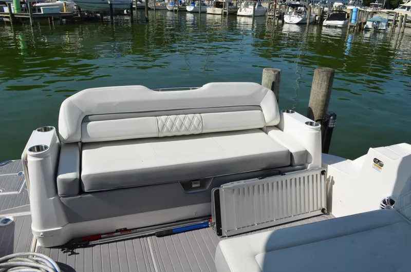  Yacht Photos Pics 2023 Regal 36 Grande Coupe boat seating area at a marina dock.