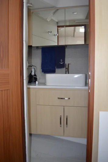  Yacht Photos Pics 2023 Regal 36 Grande Coupe bathroom with modern sink and wooden cabinetry.