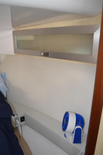  Yacht Photos Pics 2023 Regal 36 Grande Coupe interior with modern cabinetry and compact fan.