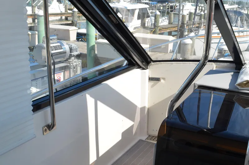  Yacht Photos Pics Interior view of 2023 Regal 36 Grande Coupe yacht, showcasing sleek design and marina backdrop.
