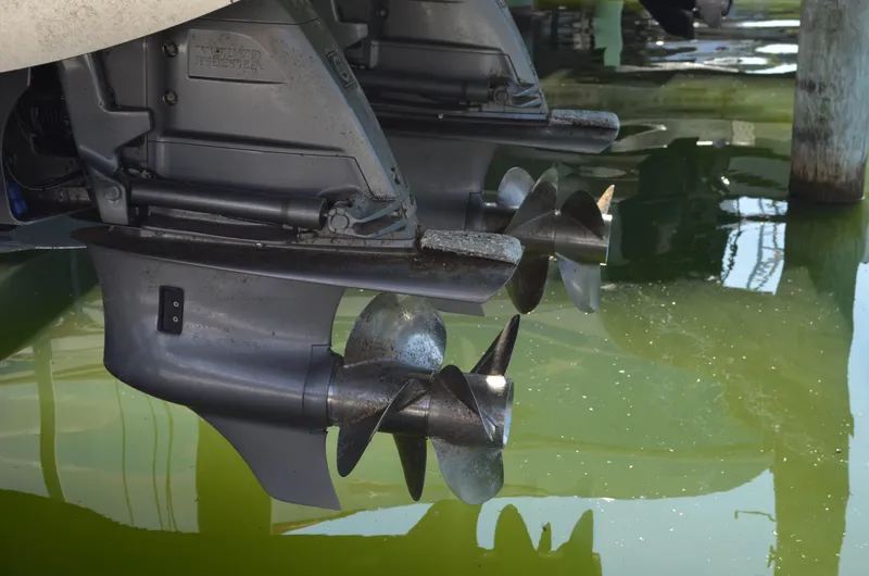  Yacht Photos Pics 2023 Regal 36 Grande Coupe boat propellers in water, showcasing dual outboard engines.