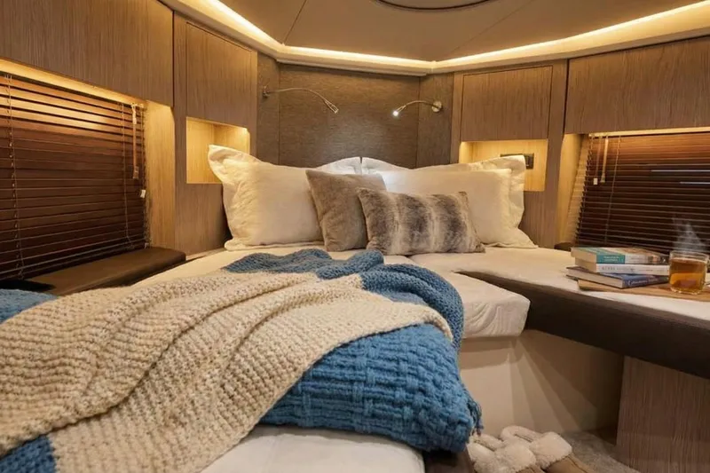 Yacht Photos Pics Luxurious 2024 Sessa Marine C44 Cruiser cabin with cozy bedding and ambient lighting.