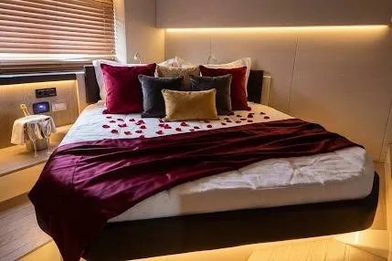  Yacht Photos Pics Luxurious bedroom in 2024 Sessa Marine C44 Cruiser with elegant decor and ambient lighting.