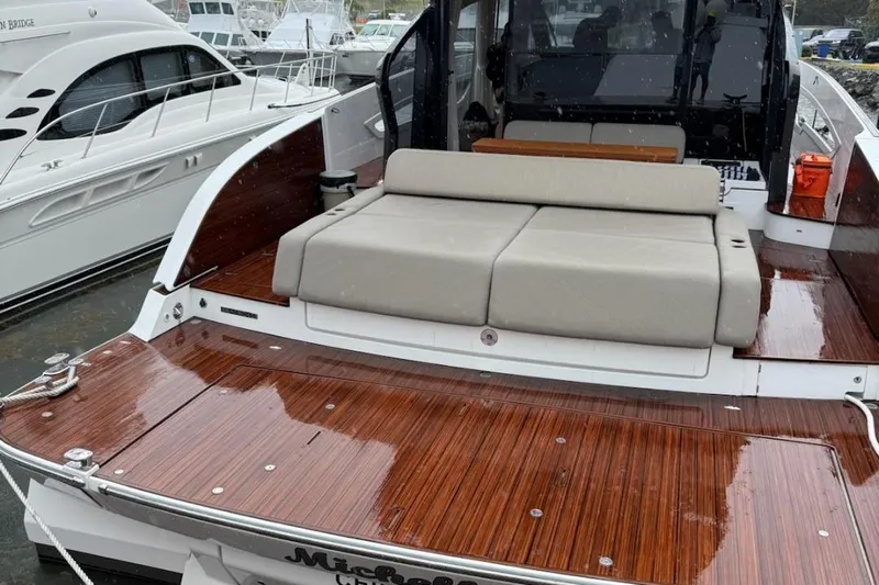 Michelle Yacht Photos Pics Azimut SeaDeck6 2025 yacht with sleek wooden deck and comfortable seating.