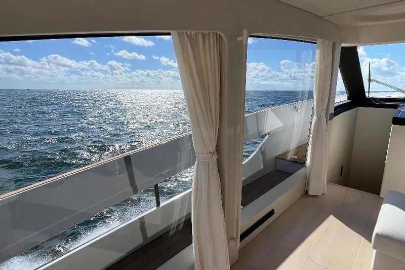 Michelle Yacht Photos Pics Interior view of 2025 Azimut SeaDeck6 yacht with ocean scenery through large windows.