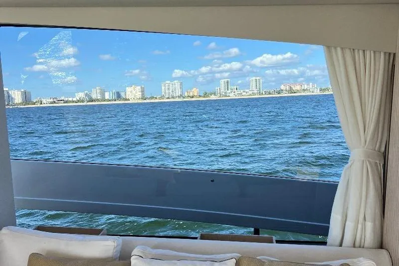 Michelle Yacht Photos Pics View from 2025 Azimut SeaDeck6 yacht window, overlooking ocean and city skyline.