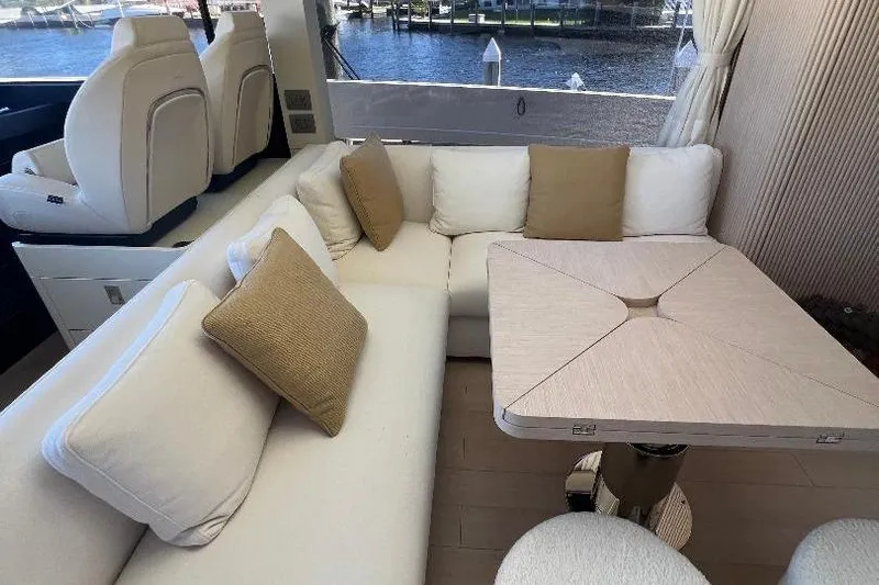 Michelle Yacht Photos Pics Luxurious interior of 2025 Azimut SeaDeck6 yacht with elegant seating and table.
