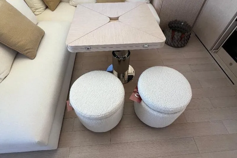 Michelle Yacht Photos Pics Interior of 2025 Azimut SeaDeck6 yacht with modern table and plush seating.