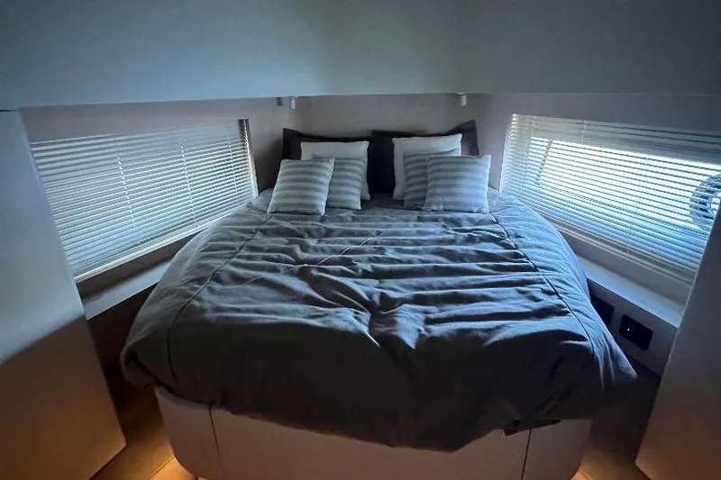 Michelle Yacht Photos Pics Luxurious bedroom interior of 2025 Azimut SeaDeck6 yacht with cozy bedding and modern design.