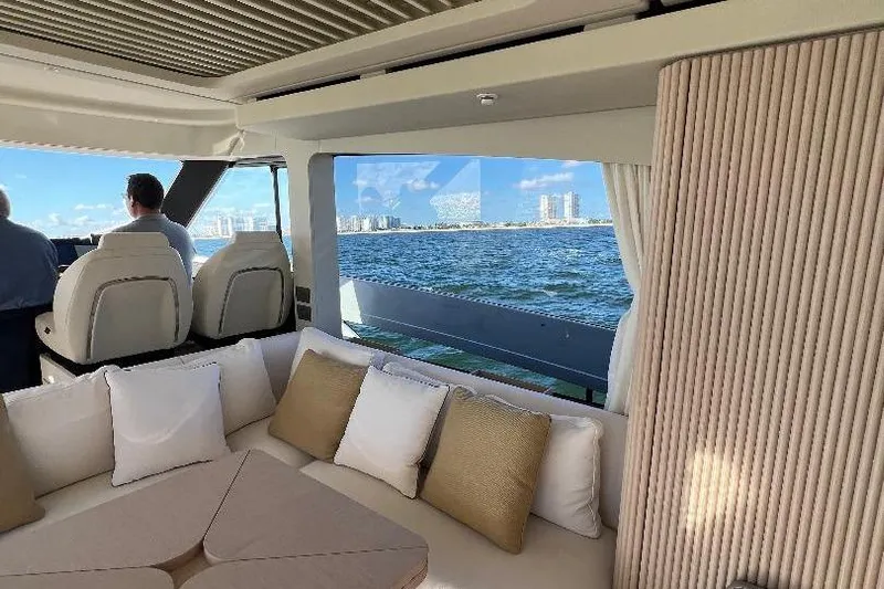 Michelle Yacht Photos Pics Luxurious interior of 2025 Azimut SeaDeck6 yacht with ocean view and plush seating.