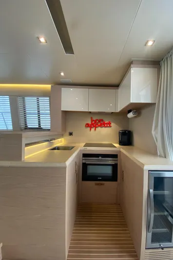 Soulshine Yacht Photos Pics Modern kitchen interior of 2017 Beneteau Monte Carlo MC6 yacht with sleek cabinetry and appliances.