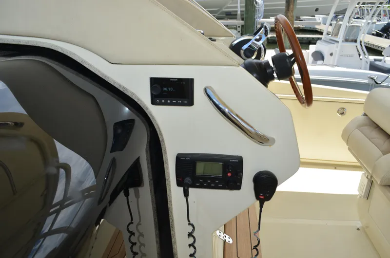  Yacht Photos Pics 2016 Chris-Craft Launch 36 cockpit with steering wheel, controls, and beige seating.