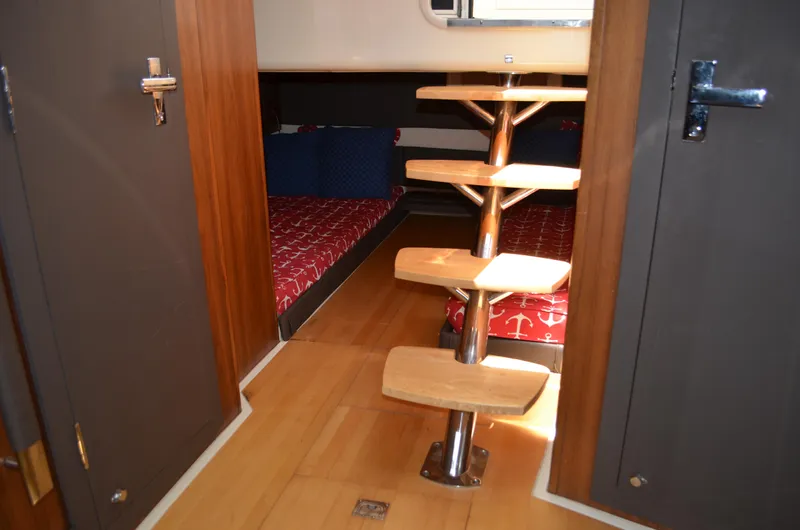  Yacht Photos Pics 2016 Chris-Craft Launch 36 cabin interior with wooden steps and twin beds.