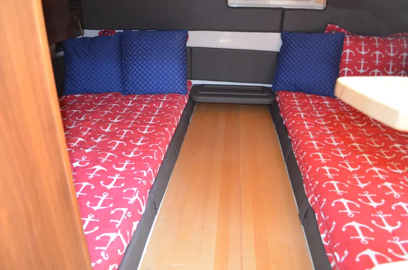  Yacht Photos Pics 2016 Chris-Craft Launch 36 cabin with nautical-themed bedding and wooden flooring.