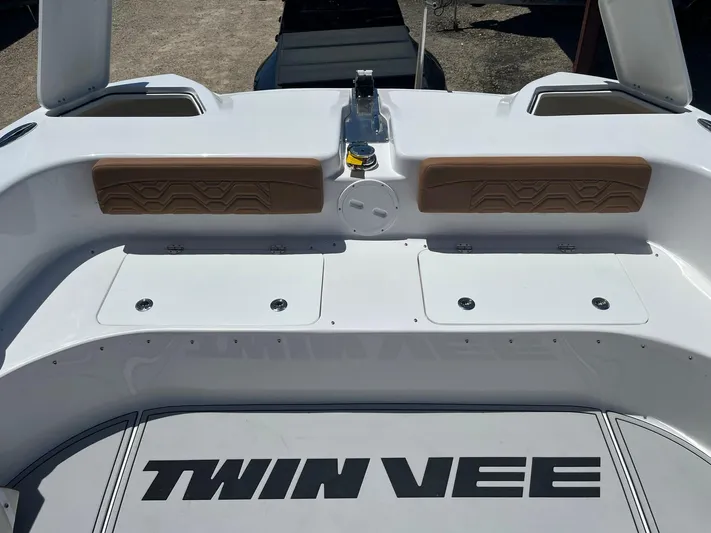  Yacht Photos Pics 2023 Twin Vee 340 GFX boat deck with storage compartments and cushioned seating.