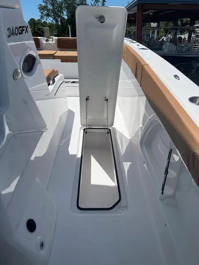  Yacht Photos Pics 2023 Twin Vee 340 GFX boat with open storage compartment.