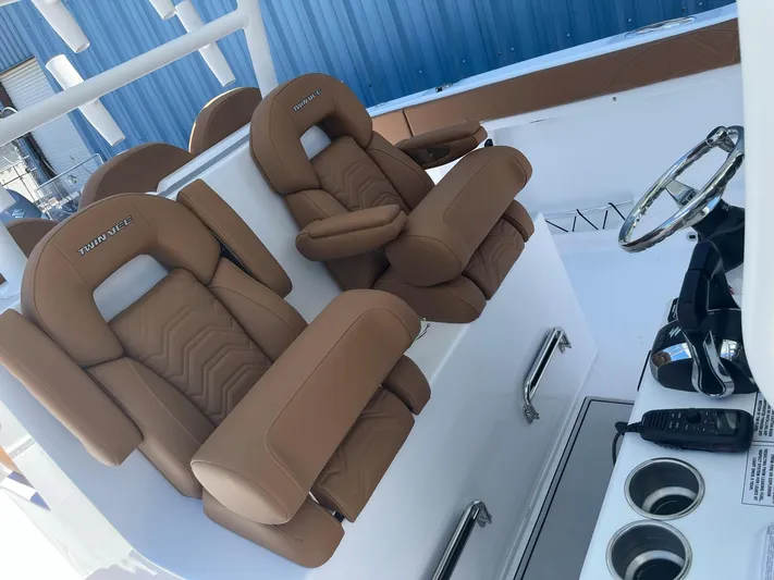  Yacht Photos Pics 2023 Twin Vee 340 GFX boat with luxurious brown captain seats and modern helm.