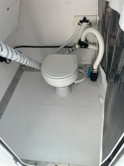  Yacht Photos Pics 2023 Twin Vee 340 GFX boat bathroom with white marine toilet and plumbing.