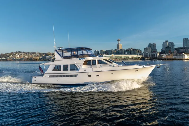 Sumo Yacht Photos Pics 1991 Tollycraft 57 Pilothouse Motor Yacht cruising near city skyline.