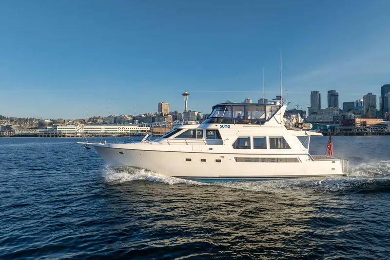 Sumo Yacht Photos Pics 1991 Tollycraft 57 Pilothouse Motor Yacht cruising near city skyline.