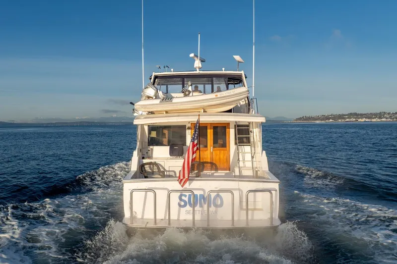 Sumo Yacht Photos Pics 1991 Tollycraft 57 Pilothouse Motor Yacht cruising on open water.