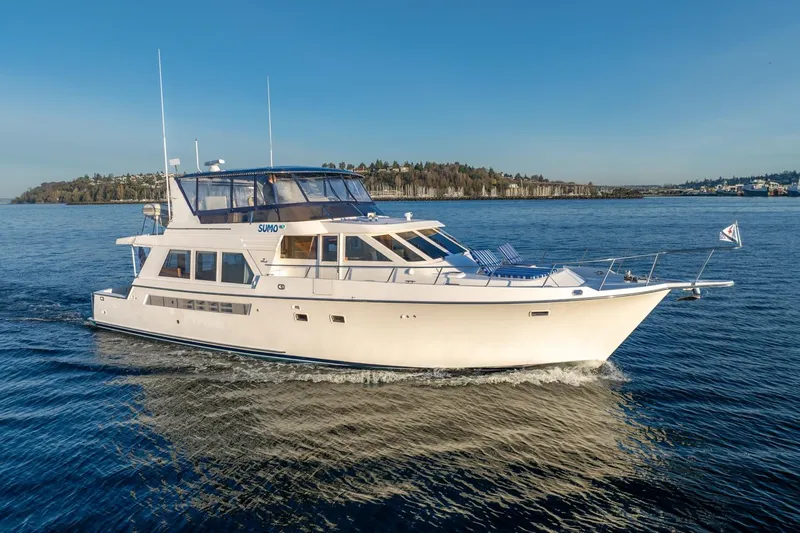 Sumo Yacht Photos Pics 1991 Tollycraft 57 Pilothouse Motor Yacht cruising on calm waters under clear skies.