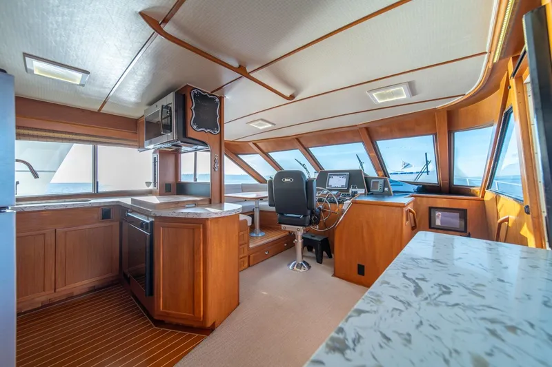 Sumo Yacht Photos Pics Interior of 1991 Tollycraft 57 Pilothouse Motor Yacht with modern helm and kitchen area.
