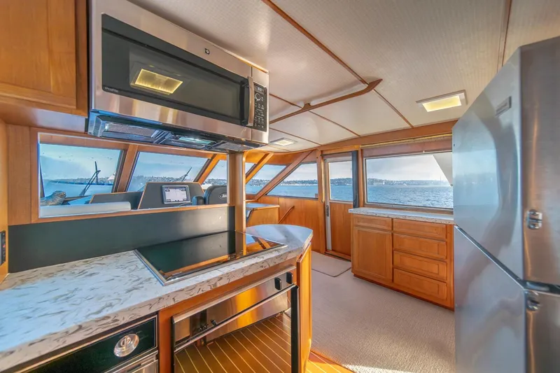 Sumo Yacht Photos Pics Interior of 1991 Tollycraft 57 Pilothouse Motor Yacht with modern kitchen and ocean view.