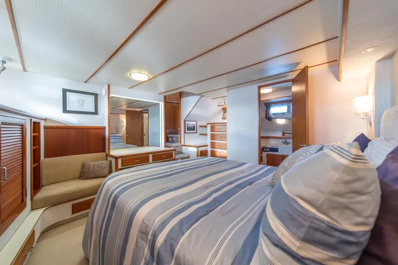 Sumo Yacht Photos Pics Luxurious bedroom interior of 1991 Tollycraft 57 Pilothouse Motor Yacht with striped bedding.