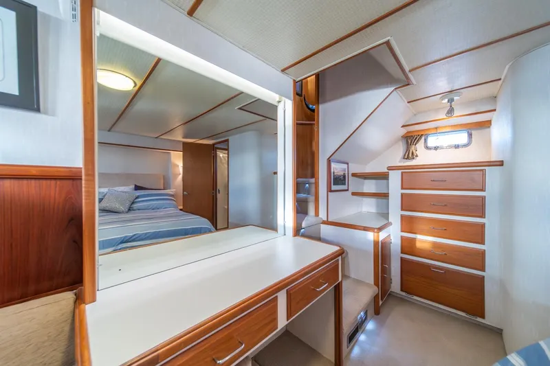 Sumo Yacht Photos Pics 1991 Tollycraft 57 Pilothouse Motor Yacht interior with bedroom, vanity, and wooden cabinetry.