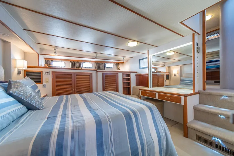 Sumo Yacht Photos Pics Luxurious bedroom interior of 1991 Tollycraft 57 Pilothouse Motor Yacht with striped bedding.