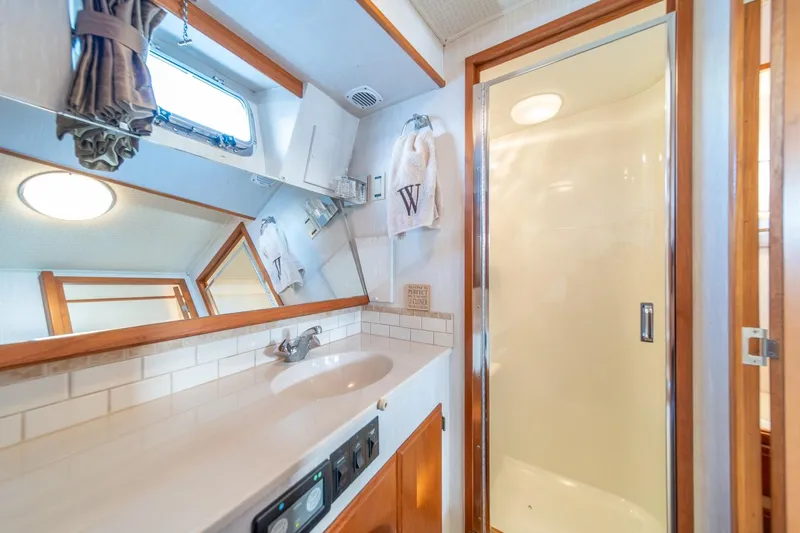 Sumo Yacht Photos Pics Bathroom interior of 1991 Tollycraft 57 Pilothouse Motor Yacht with shower and sink.