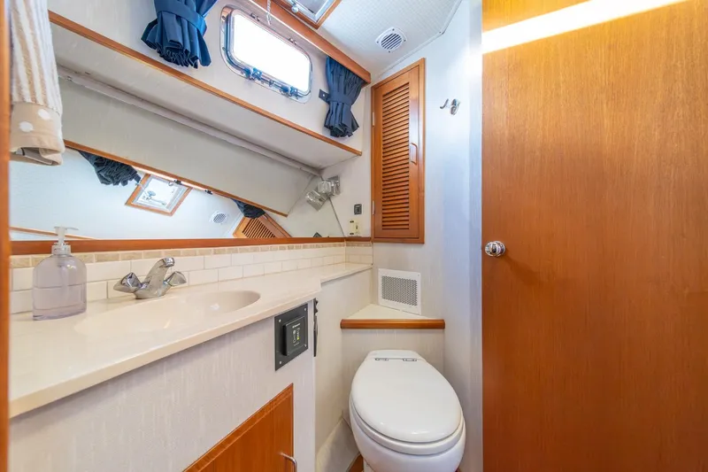 Sumo Yacht Photos Pics Bathroom interior of 1991 Tollycraft 57 Pilothouse Motor Yacht, featuring sink and toilet.
