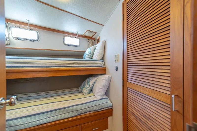 Sumo Yacht Photos Pics Bunk beds in 1991 Tollycraft 57 Pilothouse Motor Yacht cabin with wooden accents.