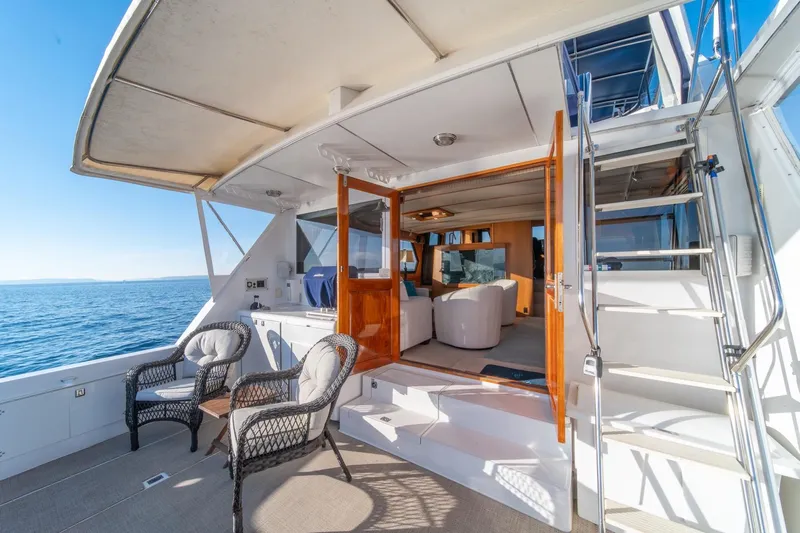 Sumo Yacht Photos Pics Luxurious 1991 Tollycraft 57 Pilothouse Motor Yacht with elegant outdoor seating and ocean view.