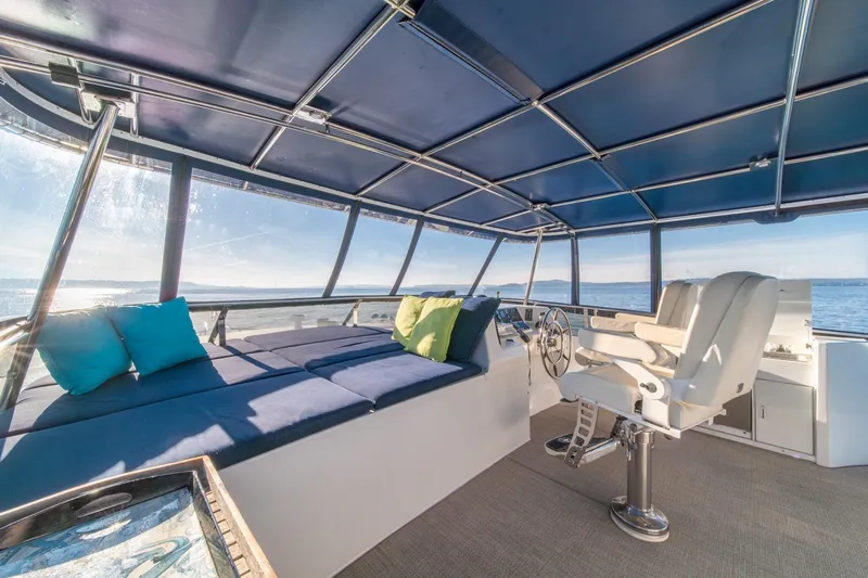 Sumo Yacht Photos Pics Luxurious 1991 Tollycraft 57 Pilothouse Motor Yacht interior with seating and ocean view.