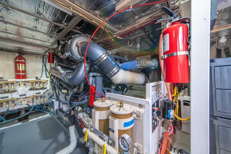 Sumo Yacht Photos Pics Engine room of 1991 Tollycraft 57 Pilothouse Motor Yacht with fire extinguisher and machinery.